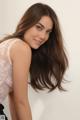 A woman with long brown hair posing for a picture.